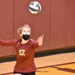 Macy Furtwangler (#12) prepares to launch a serve. Photo by Kevin Hanson.