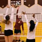 Samantha Darby (#3) goes high for a kill. Photo by Kevin Hanson.