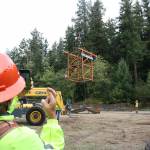 An observer on Mount Peak keeps his fingers crossed that the Chinook helicopter will be able to lift the framework of the fire lookout tower safety to the top of the mountain. Photo by Ray Miller-Still