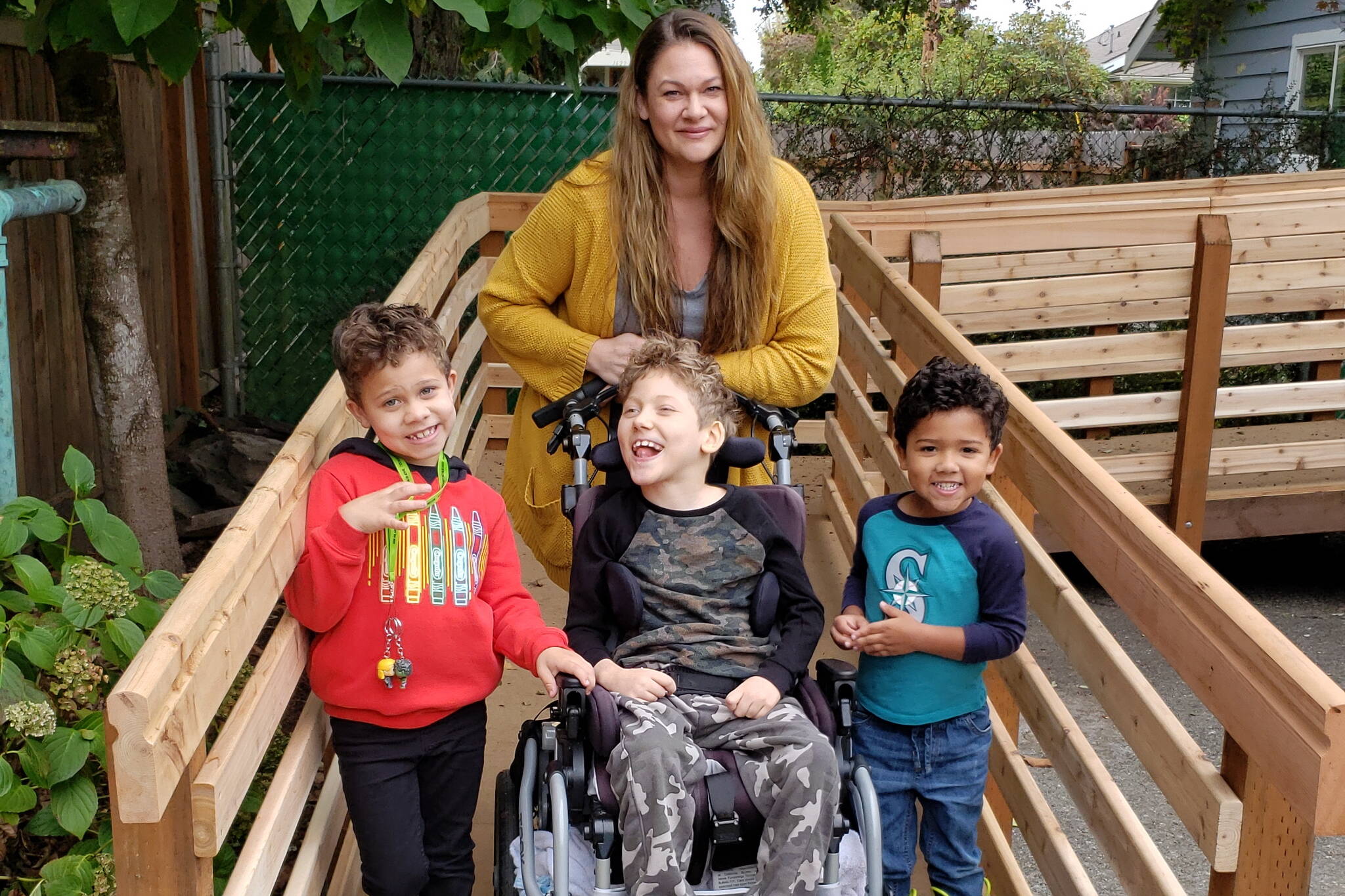 Tiffany Locklear poses for a picture with her three sons at the foot of their completed accessibility ramp in Enumclaw on Wedneday, September 29. Courtesy photo.