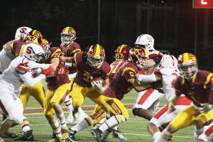 Running back Emmit Otero breaks through the crowd early on in the homecoming game against the Steilacoom Sentinels. Photo by Ray Miller-Still