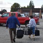 Volunteers load hot meals for seniors in the Enumclaw Senior Center parking lot. Photo by Alex Bruell