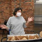 RFWF employee Sandy Merrill describes the process of cooking the hundreds of meals delivered three times a week to seniors across Enumclaw. Photo by Alex Bruell