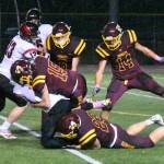 The White River defense stuffed the visiting Cardinals much of the night. Doing the honors here are Landon Mollett (15) and Logan Lisherness (23).