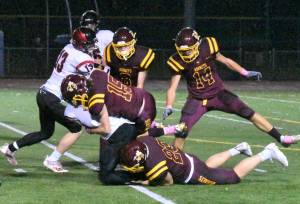 The White River defense stuffed the visiting Cardinals much of the night. Doing the honors here are Landon Mollett (15) and Logan Lisherness (23).