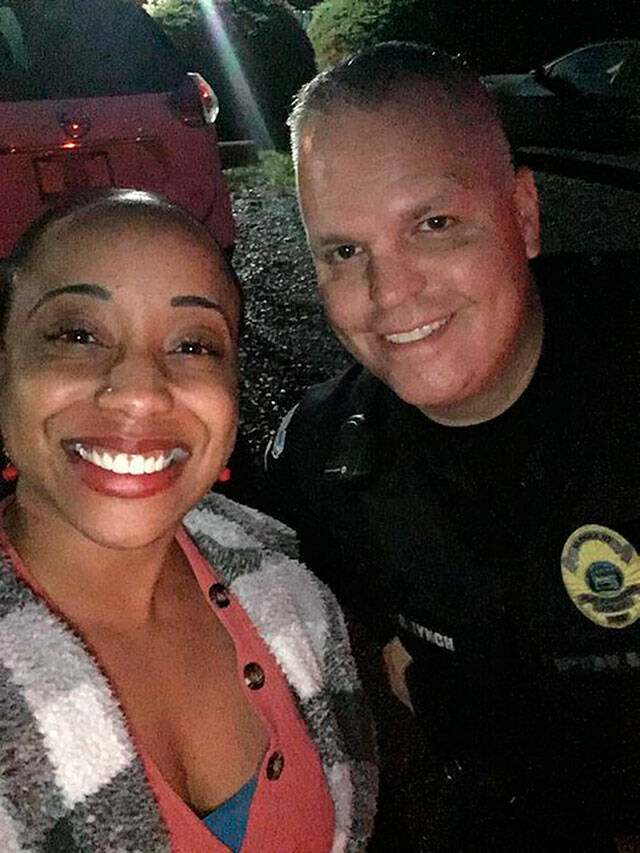 Sientje Morris and Black Diamond Sgt. Brian Lynch during a recent traffic stop where Lynch helped Morris get her car towed and repaired  all at no cost to her. Photo courtesy Black Diamond Police Department