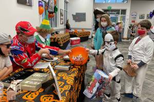 Dr. Rick Molen, left, weighing candy brought in by more than 482 participants in this year's candy buy-back at Molen Orthodontists. Courtesy photo