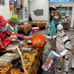 Dr. Rick Molen, left, weighing candy brought in by more than 482 participants in this year's candy buy-back at Molen Orthodontists. Courtesy photo