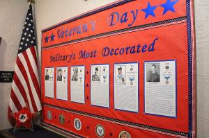 Photos by Ray Miller-Still

The young and old alike honored and celebrated their local veterans during Veterans Day by donating money to the Enumclaw VFW Post 1949. In past years,
due to COVID, donations to the post have lagged, and the VFW hoped this year more money would be donated to go toward various programs that help
out veterans with medical bills, emergency relocation costs, and other challenges they may face. Pictured at the local QFC is Barb Kindvarter and the Short
family. Meanwhile, at the Buckley Federation of Eagles No. 1387, an annual display for Veterans Day has been constructed by Helen Whitehouse for locals to
learn about anything and everything there is to know about veterans, from honoring local members of the Eagles Club and recognizing the military’s most
decorated heroes to a list of entertainers and sports figures involved with the armed forces and “The Old Man and a Bucket of Shrimp,” the true story of
Eddie Rickenbacker’s survival at sea. The display is available for the public to view, and will remain up for a while longer