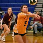 White River libero Kelli Kaelin keeps the ball in play as teammate Sydney Schultz approaches the net during the Hornets district match with North Kitsap.