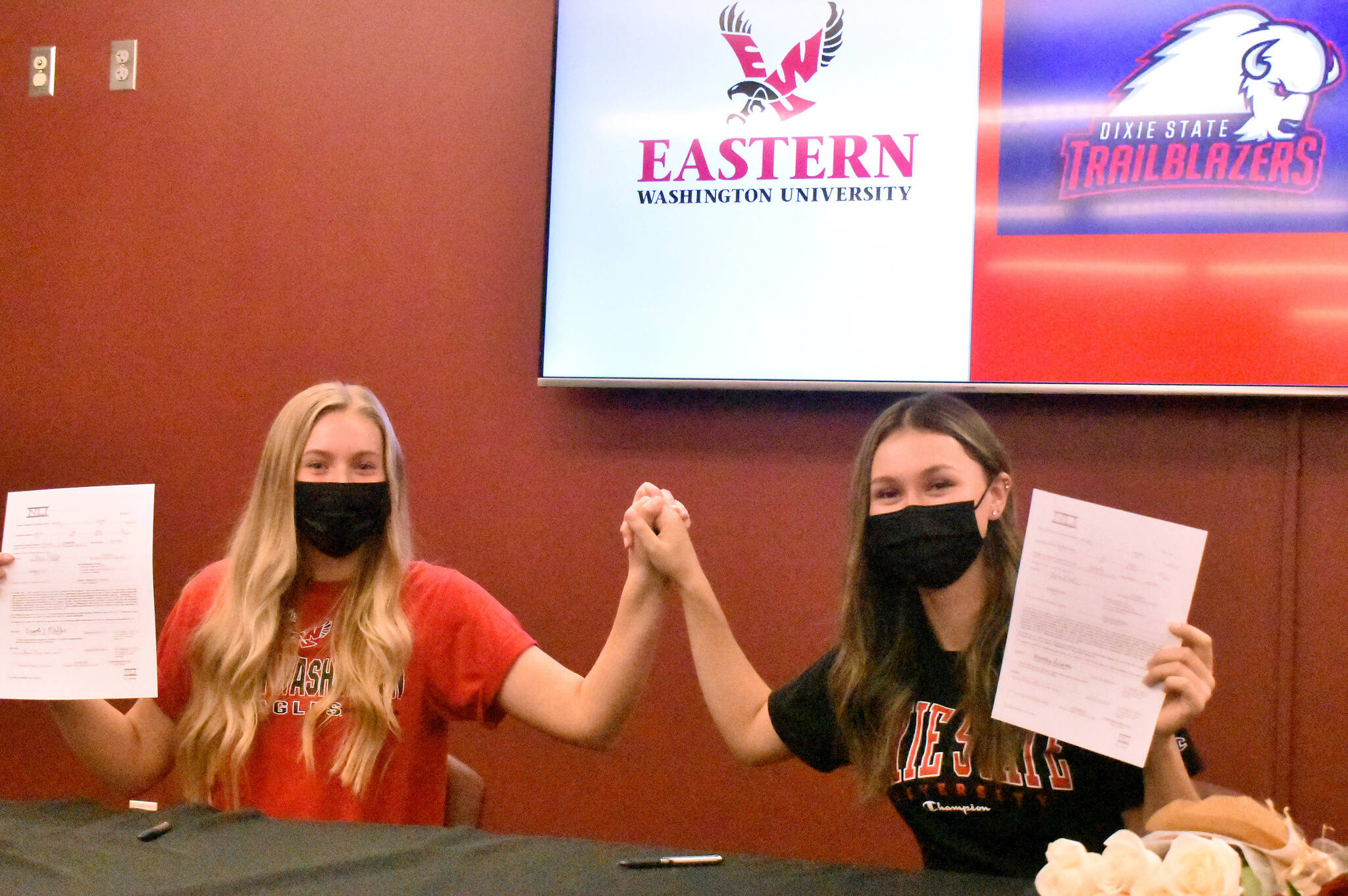 PHOTO BY KEVIN HANSON White Rivers Brooke Mahler (left) and Brooke Gelinas celebrate at the conclusion of a signing ceremony at their school. Each will be playing collegiate golf next year.