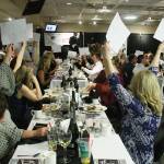 One of the highlights of Holiday Fantasy has been outright donations to a worthy cause. Here, attendees show their support during the 2018 event. This year, the event will be holding a virtual auction over four days while having the dinner at the Enumclaw Thunder Dome museum. Photo by Kevin Hanson