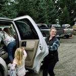 The Pratt family loads back in their car, Christmas tree in tow.
