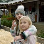 Charlie puts an arm around her little sister Kacey on a hay ride around the tree farm.