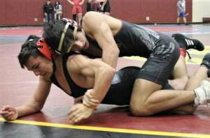 Photo by Kevin Hanson 
Tyler Ramirez, a captain for this seasons Enumclaw High wrestling team, gets the better of an opponent during a match last season.