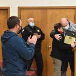 Councilmember Ron Smith embraces outgoing Mayor Pat Johnson after presenting her with a plaque commemorating her decades of public service in Buckley. Photo by Alex Bruell