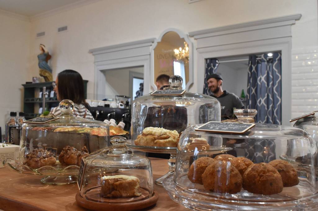 Luke Wilbanks chats with his employees during a quiet Friday morning at Anchor House Coffee Roasters.