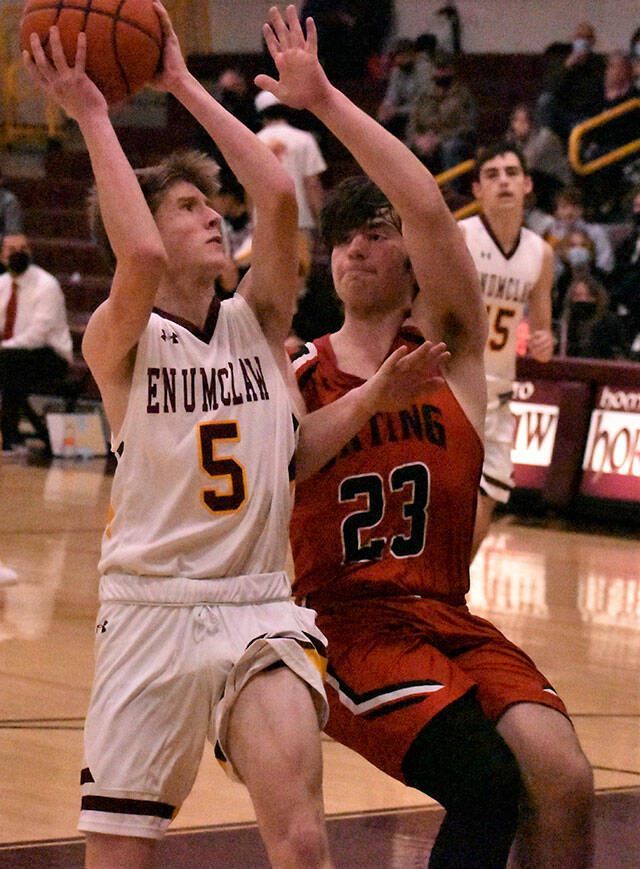 The Enumclaw High boys had little trouble picking up a league victory Dec. 15 when the Orting Cardinals visited Chuck Smith Gymnasium. In this photo, Liam Leonard (5) gets a shot off despite pressure from Ortings Mason McCall. Photo by Kevin Hanson
