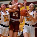 It was a Hornet-Hornet battle for a rebound Friday night when the girls' teams from White River and Enumclaw met in Buckley. Coming away with the ball is White River freshman Vivian Kingston; also in the scramble are teammate Josie Jacobs and Enumclaw's Bella Firnkoess (21). Photo by Kevin Hanson