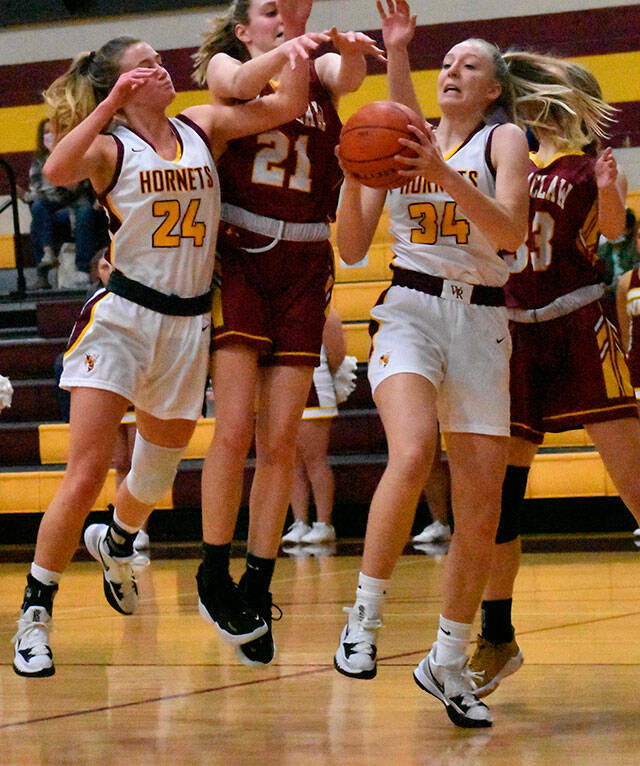 It was a Hornet-Hornet battle for a rebound Friday night when the girls teams from White River and Enumclaw met in Buckley. Coming away with the ball is White River freshman Vivian Kingston; also in the scramble are teammate Josie Jacobs and Enumclaws Bella Firnkoess (21). Photo by Kevin Hanson