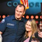 Mitchell Oake stands for pictures with his wife Kayla after she and their sons Hudson and Trace pin his new badge. Photo by Alex Bruell