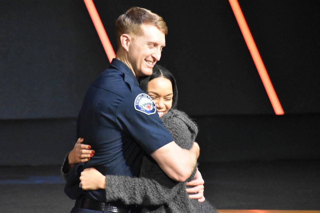 Photo by Alex Bruell
Ira Holt shares a hug with his wife LaToya Holt, who pinned his badge.