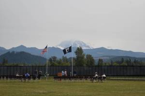 Photos by Alex Bruell 
Mount Rainier rises behind The Moving Wall as its sits in a grassy field near Sunrise Elementary the afternoon of Thursday, Aug. 5.