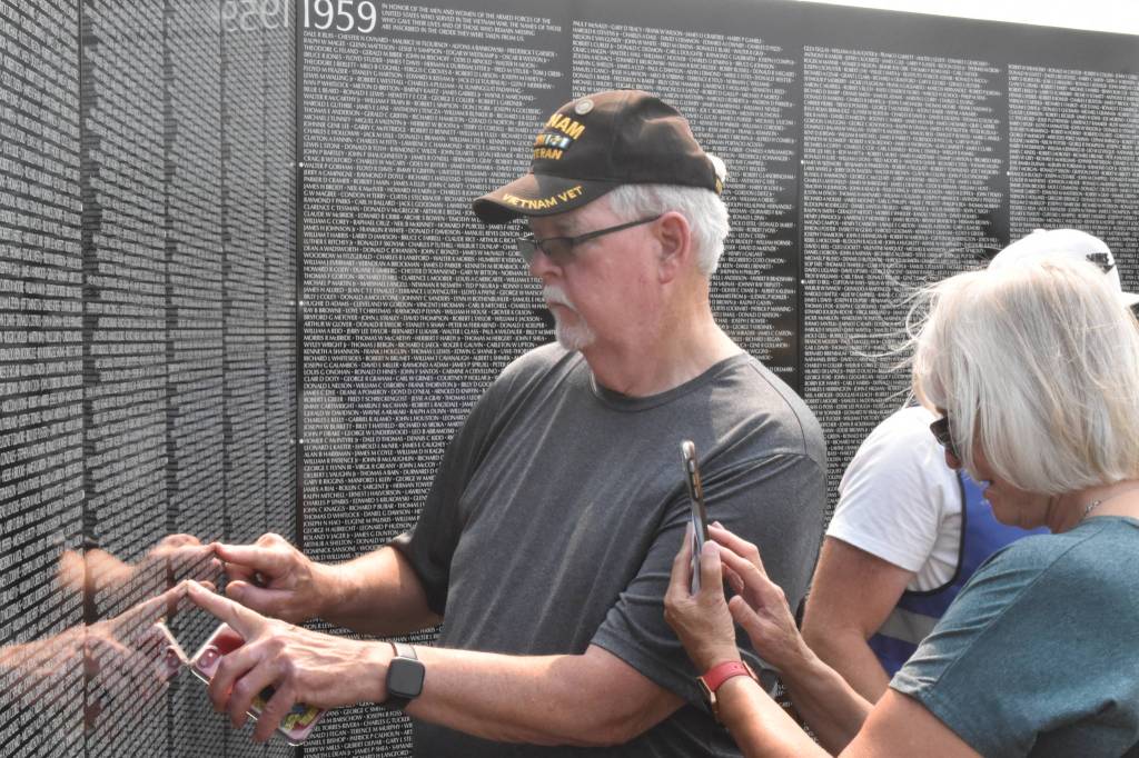 Daniel and Marie Hertlein look for a name on The Moving Wall.