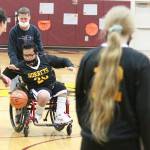 Rafael Jimenez (20) dribbles down the court with the help of local photographer Tim Dehnert. Photo by Ray Miller-Still
