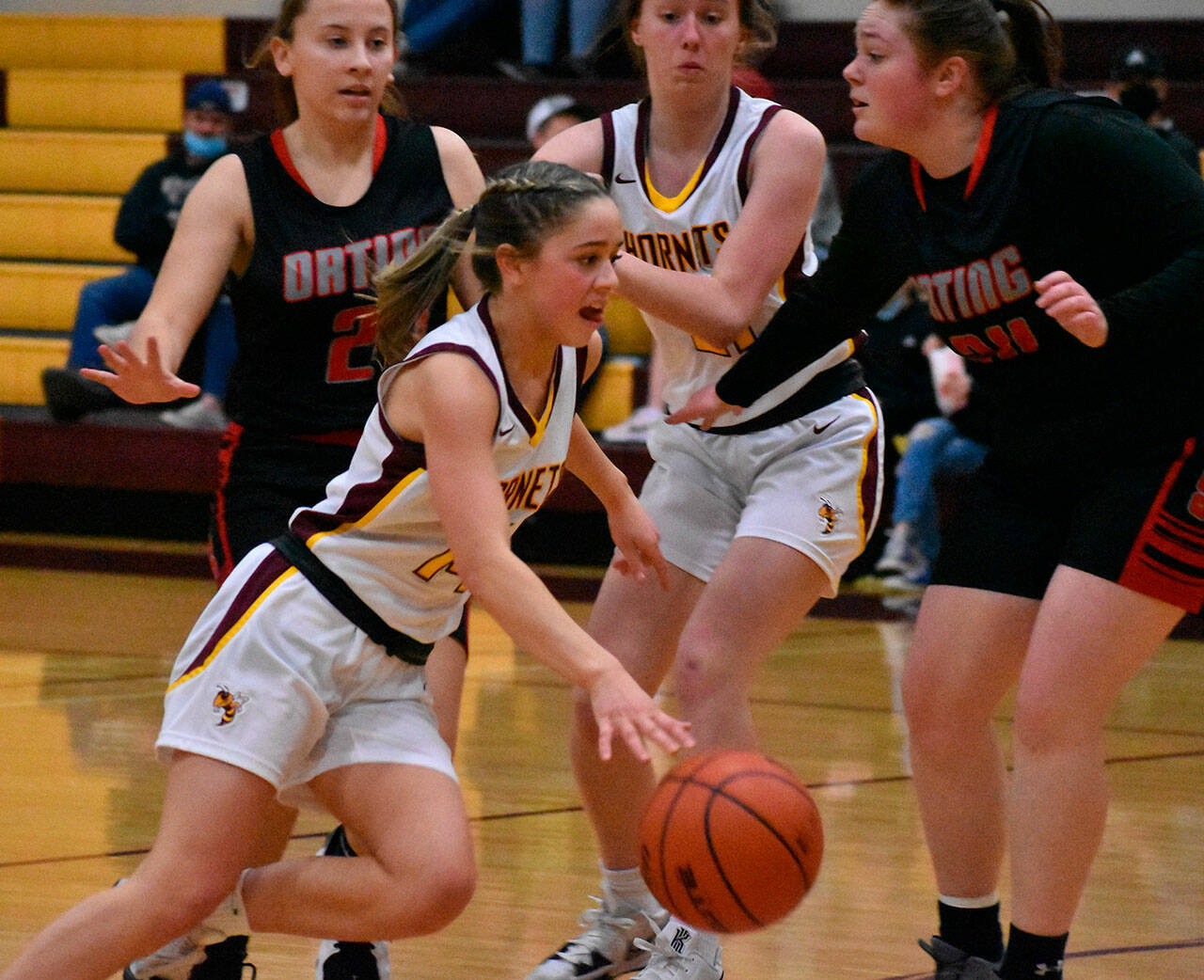 There was absolutely no drama in the White River High gymnasium the evening of Feb. 1, when the league-leading Hornets hosted the Orting Cardinals. White River scored 56 points in the first half and Orting went scoreless the entire third and fourth quarters, contributing to a 77-8 win for the Hornets. In these photos, Lexie Banks (above) challenges the Cards on a drive to the hoop; Ava Bright (below) lays in two of her 12 points and. Photo by Kevin Hanson