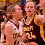 Enumclaw's Charlee Torgison heads to the hoop, guarded by White River's Josie Jacobs, during Friday night basketball action at EHS. It was the South Puget Sound League 2A finale and featured the cream of the crop: White River entered with a 13-0 league record while Enumclaw was just a stop behind at 12-1. Avenging an earlier loss to their Buckley foes, the Enumclaw girls wound up on the winning end of an exciting 70-65 contest. The Plateau neighbors carry co-champion honors into postseason play. Photo by Kevin Hanson