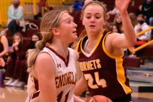 Enumclaw's Charlee Torgison heads to the hoop, guarded by White River's Josie Jacobs, during Friday night basketball action at EHS. It was the South Puget Sound League 2A finale and featured the cream of the crop: White River entered with a 13-0 league record while Enumclaw was just a stop behind at 12-1. Avenging an earlier loss to their Buckley foes, the Enumclaw girls wound up on the winning end of an exciting 70-65 contest. The Plateau neighbors carry co-champion honors into postseason play. Photo by Kevin Hanson