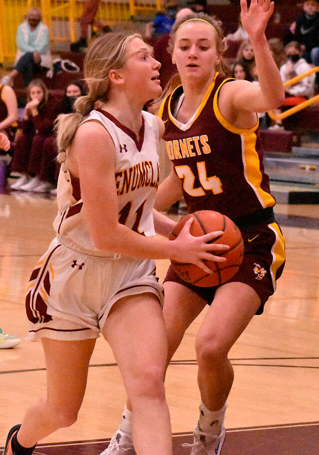 Enumclaws Charlee Torgison heads to the hoop, guarded by White Rivers Josie Jacobs, during Friday night basketball action at EHS. It was the South Puget Sound League 2A finale and featured the cream of the crop: White River entered with a 13-0 league record while Enumclaw was just a stop behind at 12-1. Avenging an earlier loss to their Buckley foes, the Enumclaw girls wound up on the winning end of an exciting 70-65 contest. The Plateau neighbors carry co-champion honors into postseason play. Photo by Kevin Hanson