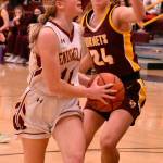 Enumclaws Charlee Torgison heads to the hoop, guarded by White Rivers Josie Jacobs, during Friday night basketball action at EHS. It was the South Puget Sound League 2A finale and featured the cream of the crop: White River entered with a 13-0 league record while Enumclaw was just a stop behind at 12-1. Avenging an earlier loss to their Buckley foes, the Enumclaw girls wound up on the winning end of an exciting 70-65 contest. The Plateau neighbors carry co-champion honors into postseason play. Photo by Kevin Hanson