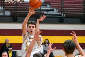 Pictured is Hornets' Carson Voellger sending a pass to teammate Rylan Donovan (11) during the home-court, 74-62 win game against Bremerton on Feb. 16. File photo by Kevin Hanson