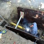 Enumclaw welder Nick Burden improving the gas line underneath Warner Avenue. Photo courtesy the city of Enumclaw