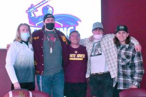 During a ceremony at White River High, a quartet of Hornet seniors signed letters sealing their agreement to play college ball before gathering for a photo with their coach, Kenny Pirone. From left are Cole Cashman, Wyatt Davis, Pirone, Ryan Stapleton and Payne Plaster. Photo by Kevin Hanson