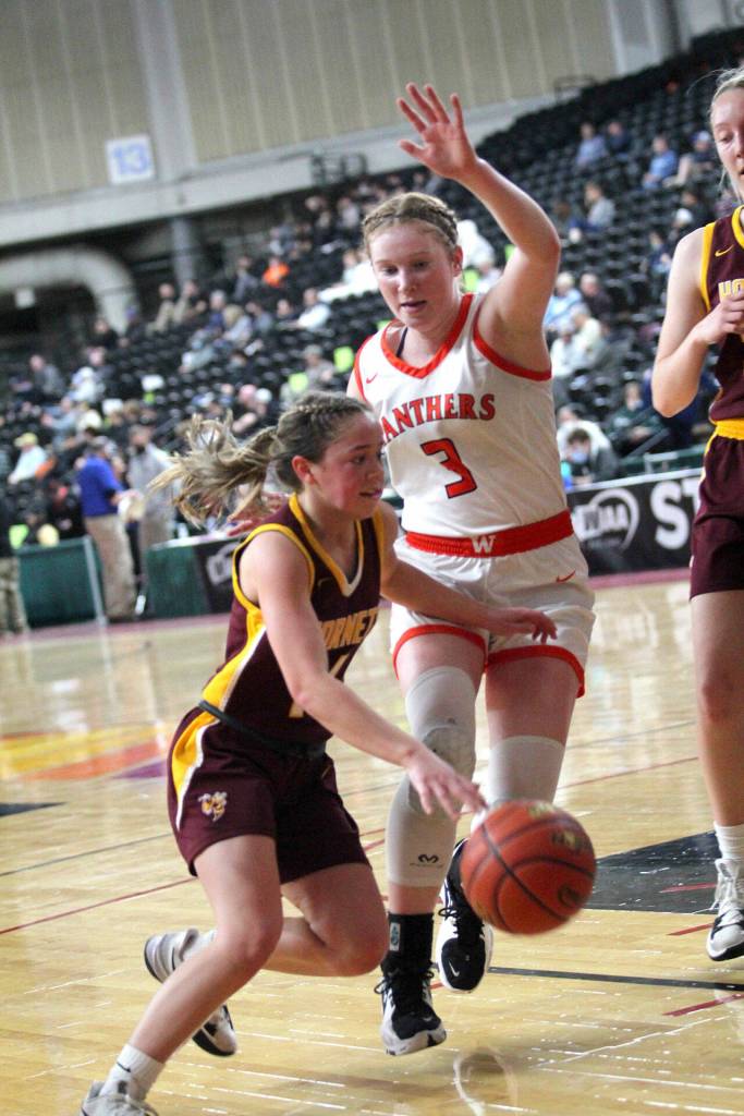 White Rivers Lexie Banks attempts a drive to the basket around a Washougal player. Photo courtesy Northwest Sports Photography