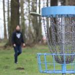 Chris Waugh makes a shot at the No. 9 hole at the Farmer's Park disc golf course in Enumclaw. Photo by Ray Miller-Still