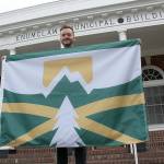 Kyle Miller, one of more than 50 people who entered Enumclaw's design-a-flag contest last year, had his design chosen to represent the city. Photo by Ray Miller-Still