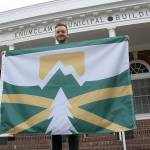 Kyle Miller, one of more than 50 people who entered Enumclaws design-a-flag contest last year, had his design chosen to represent the city. Photo by Ray Miller-Still