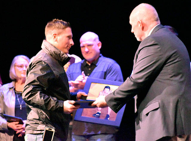Members of the Hall of Fame wrestling team accept their award from Athletic Director Chris Gibson. Photo by Kevin Hanson