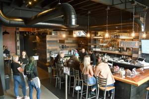 Patrons deliver Pursuit Distilling's new Railroad Ave. taproom a busy night on Friday, March 25, the day after its grand opening. Photos by Alex Bruell