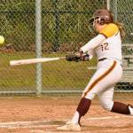 Megan Klapperich puts a ball into play during the Hornets lopsided fastpitch victory over the Washington Patriots. Photo by Kevin Hanson