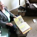 Dorothy Sleigh has kept a few things from her time with the Enumclaw Chamber of Commerce, including an entire scrapbook of news clippings, photos, and awards. Photo by Ray Miller-Still