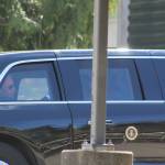 A man who appears to be President Joe Biden is seen in the back seat of a car in the presidents motorcade, departing the Green River College after the presidents speech. Photo by Alex Bruell/Sound Publishing
