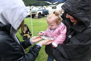 Young kids and their families had a reel good time at Uncle John's pond last weekend for the RV park's annual fishing derby, and several children managed to catch some two-plus pound whoppers. Pictured above is Jaelyn Anderson showing off her first catch of the morning to Stevie Frick. Photos by Ray Miller-Still