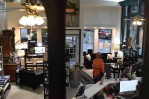 Athena Dean Holtz stands inside the new home of Redemption Press, an Enumclaw-based Christian book publisher. Formerly belonging to Almost Necessities, a gift shop, Holtz has preserved the light and airy atmosphere of the building in converting it to a bookselling and publishing house. Photo by Alex Bruell.