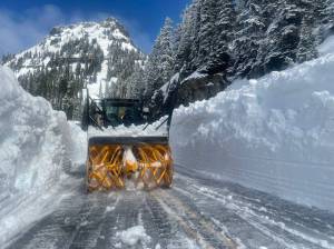WSDOT shared this image of a snow blower fighting huge walls of snow on SR 410 Chinook Pass, which crews estimated on May 19 would remain closed for a few more weeks.
