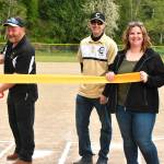 The newly-refurbished Petes Pool ballfield was celebrated with a ribbon-cutting ceremony the evening of May 11. Doing the snipping honors, joined by members of the Chinook Little League board of directors, was association president Bruce McCann. Photo by Kevin Hanson